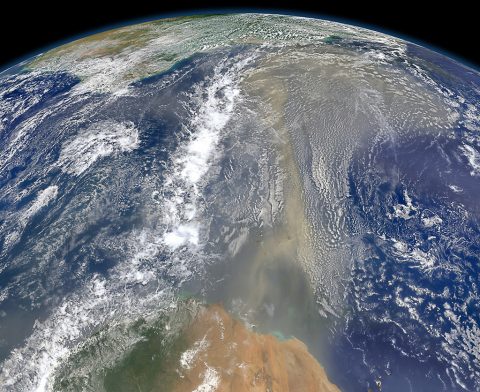 Satellites have documented that human-produced and natural air pollution can travel a long way. This 2014 NASA satellite image shows a long river of dust from western Africa (bottom of image) push across the Atlantic Ocean. (NASA)