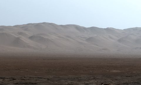 This early-morning view from the Mastcam on NASA's Curiosity Mars rover on March 16, 2016, covers a portion of the inner wall of Gale Crater. At right, the image fades into glare of the rising sun. (NASA/JPL-Caltech/MSSS)