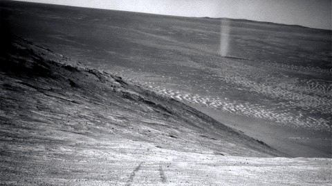 From its perch high on a ridge, NASA's Mars Exploration Rover Opportunity recorded this image of a Martian dust devil twisting through the valley below. (NASA/JPL-Caltech)