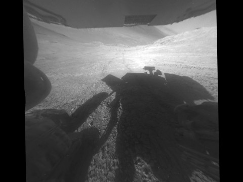 A shadow and tracks of NASA's Mars rover Opportunity appear in this March 22, 2016, image, which has been rotated 13.5 degrees to adjust for the tilt of the rover. (NASA/JPL-Caltech)