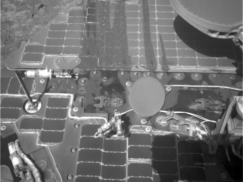 This March 21, 2016, image from the navigation camera on NASA's Mars rover Opportunity shows streaks of dust or sand on the vehicle's rear solar panel after a series of drives during which the rover was pointed steeply uphill. The tilt and jostling of the drives affected material on the rover deck. (NASA/JPL-Caltech)