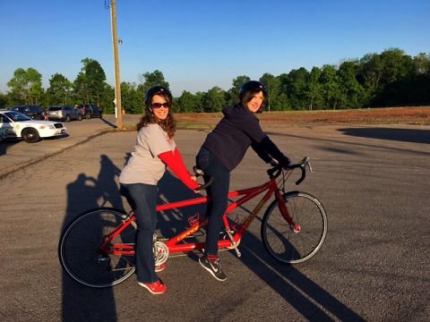 Principal Sallie Oden on the front of the bike and Assistant Principal Amy Williams on the back.