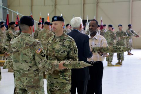 Command Sgt. Maj. Jeremy Gebhardt, 2nd Battalion, 502nd Infantry Regiment, 2nd Brigade Combat Team, 101st Airborne Division; Col. Brett G. Sylvia, commander of Strike; Honorary Colonel of the Regiment, Col. (R) Theodore Purdom and Honorary Sergeant Major of the Regiment Master Sgt. (R) Alonzo Rollins; case the colors during a traditional colors of the casing ceremony at ‘Hangar 3’, Apr. 27, 2016. (Spc. Andres Alegria, 2nd Brigade Combat Team, 101st Airborne Division (Air Assault))