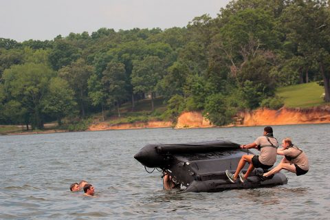 Soldiers with “Charlie Rock,” C Troop, 1st Squadron Regiment, 32nd Cavalry Regiment, 1st Brigade Combat Team, 101st Airborne Division (Air Assault) attempt to turn over a combat rubber raiding craft (CRRC), also known as the Zodiac during helocast training at Paris Landing State Park May 11, 2016. (Spc. Katie Petrosky, 5th Special Forces Group Public Affairs)