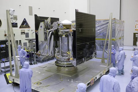 NASA's OSIRIS-REx spacecraft is revealed after its protective cover is removed inside the Payload Hazardous Servicing Facility at Kennedy Space Center in Florida. The spacecraft traveled from Lockheed Martin's facility near Denver, Colorado to Kennedy to begin processing for its upcoming launch, targeted for Sept. 8 aboard a United Launch Alliance Atlas V rocket. (NASA/Dimitri Gerondidakis)