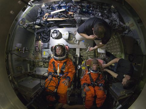 Crash-test dummies wearing modified Advanced Crew Escape System suits were installed into the crew seats of an Orion test capsule days before being dropped into NASA Langley Research Center’s Hydro Impact Basin. (NASA/David C. Bowman)