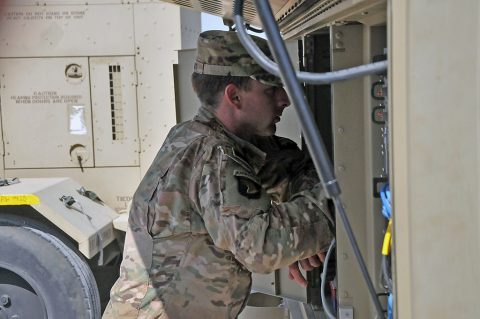 Spc. Sean Luoma, a systems operator/maintainer in Company C, 39th Brigade Engineer Battalion, Task Force Strike, checks his satellite communications equipment, May 20, 2016, in Erbil, Iraq. Luoma and other signal Soldiers deployed with Task Force Strike to ensure the more than 1,300 personnel of the Task Force can communicate throughout their area of Operations. (1st Lt. Daniel Johnson)