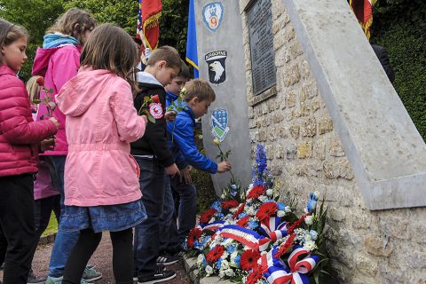 French children place flowers at the Currahee Memorial in Beuzeville au Plain, France, June 1, 2016. More than 380 service members from Europe and affiliated D-Day historical units are participating in the 72nd anniversary as part of Joint Task Force D-Day 72. (U.S. Air Force photo by Staff Sgt. Timothy Moore)