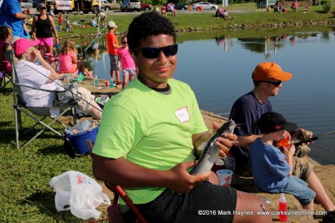 This gentleman shows off a catfish he has just caught.