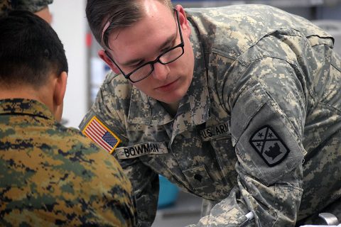 Specialist Bowman (right), a medic with the 230th Engineer Battalion, 194th Engineer Brigade, Tennessee Army National Guard, evaluates a patient during a medical training during Operation Resolute Castle on May 26, 2016 at Novo Selo Training Area, Bulgaria. As part of the exercise, Spc. Bowman was required to evaluate patients and administer IVs. (1st Lt. Matthew Gilbert, 194th Engineer Brigade)