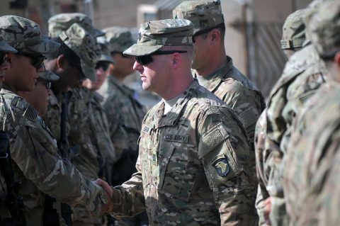 Cpt. Justin Shaw, center, commander of Company D, 1st Battalion, 26th Infantry Regiment, Task Force Strike, shakes the hands of Soldiers of Company D after their patching ceremony June 3, 2016, in Taji, Iraq. Soldiers are allowed to wear the patch for the rest of their careers, signifying service in a theater of combat operations with the 101st Airborne Division (Air Assault). (1st Lt. Daniel Johnson) 