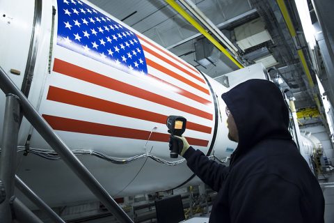 An Orbital ATK technician checks the temperature of a full-scale, test version booster for NASA's new rocket, the Space Launch System. It will take more than a month to reach the booster's cold temperature target of 40 degrees Fahrenheit inside the test facility.  (Orbital ATK)