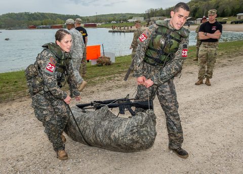 2nd Lt. Leah Mullenix (left) and 1st Lt. Edward Colon (right), Team 23, 326th Brigade Engineer Battalion, 1st Brigade Combat Team, 101st Airborne Division (Air Assault), haul their poncho raft out of Engineer lake during the swim event of the Best Sapper Competition at Fort Leonard Wood, Mo., April 19, 2016. Sappers pulled a raft carrying their individual weapon and full ruck sack. Once out of the water, they had to reassemble their ruck and complete a five-mile foot march. (U.S. Army photo courtesy of Fort Leonardwood Public Affairs)