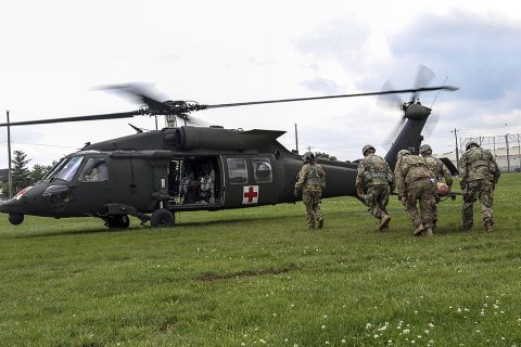 Medics with 1st Brigade Combat Team, 101st Airborne Division (Air Assault) litter carry a simulated casualty to a waiting UH-60 Blackhawk on Johnson field during the brigade’s Expert Field Medical Badge train-up May 26, 2016. Soldiers practiced loading causalities while the aircraft’s rotor wings continue to spin because it will be one of more than 200 tasks they are tested on at the end of June. (Sgt. Samantha Stoffregen, 1st Brigade Combat Team, 101st Airborne Division (Air Assault) Public Affairs)