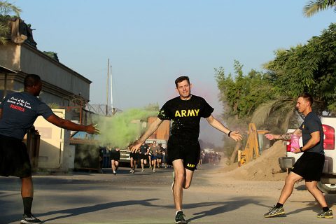 1st Lt. Benjamin Williams, executive officer for the Headquarters Support Company, Headquarters and Headquarters Battalion, 101st Airborne Division (Air Assault), runs through a color station during the Combined Joint Forces Land Component Command – Operation Inherent Resolve Color Run on Forward Operating Base Union III, Baghdad, July 2, 2016. (U.S. Army photo by Sgt. Katie Eggers/Released) 