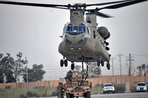 A hook-up team, consisting of Soldiers with 1st Battalion, 502nd Infantry Regiment, Task Force Strike, attach an M1151 Humvee to a CH-47 Chinook helicopter during a sling load training exercise July 16 2016, in Taji, Iraq. (1st Lt. Daniel Johnson)