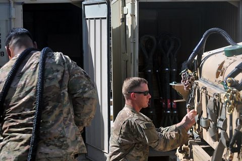 Sgt. Robert Rojas, left, and Staff Sgt. Thomas Gardner, right, with the 526th Brigade Support Battalion, Task Force Strike, prepare an M1151 Humvee for sling load operations July 15, 2016, in Taji, Iraq. The 526th BSB is the base operating support integrator for Coalition forces on Camp Taji, responsible for integrating the operations of Coalition forces with the Iraqi security forces. (1st Lt. Daniel Johnson)