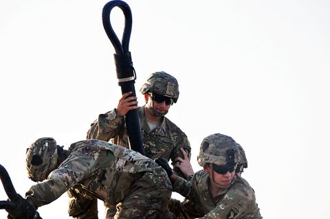 A hook-up team, consisting of Soldiers with 1st Battalion, 26th Infantry Regiment, Task Force Strike, prepare an M1151 Humvee for sling load operations, July 16 2016, in Taji, Iraq. The Soldiers conducted the training to maintain their proficiency in sling load operations while deployed to Iraq in support of Operation Inherent Resolve. (1st Lt. Daniel Johnson) 