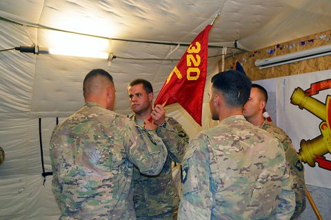 Lt. Col. Charles W. Kean, left, commander, of 1st Battalion, 320th Field Artillery Regiment, Task Force Strike, passes the Battery C guidon to Capt. Joseph Berlin, center, symbolizing his new authority as the commander of the battery at Kara Soar Base, Iraq, July 25, 2016. Battery C’s mission in Iraq is to provide precision, surface-to-surface fires during Operation Inherent Resolve. (Maj. Ireka Sanders)