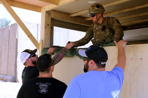 Mat Best, left, CEO of Article 15 Clothing and Army Ranger veteran, and Nick Palmisciano, founder of Ranger Up clothing company and Army veteran, talk with a group of Combined Joint Forces Land Component Command – Operation Inherent Resolve Soldiers after a viewing of their movie, “Range 15,” at Forward Operating Base Union III, Baghdad, July 10, 2016. (U.S. Army photo by Sgt. Katie Eggers) 