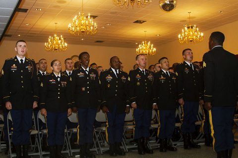 Sgt. Tevyn Waters, a motor transport operator with 74th Transportation Company, 129th Combat Sustainment Support Battalion, 101st Airborne Division Sustainment Brigade, 101st Abn. Div. (Air Assault), stands in front of his peers as he leads the Noncommissioned Officer Creed during the NCO Induction Ceremony at the Dale Wayrynen Recreation Center, Aug. 11, 2016. (Sgt. Neysa Canfield)