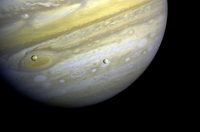 Voyager 1 took this photo of Jupiter and two of its satellites (Io, left, and Europa) on Feb. 13, 1979. This photo was assembled from three black and white negatives by the Image Processing Lab at Jet Propulsion Laboratory. (NASA/JPL)