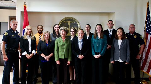 (L to R) Chief Al Ansley, Nicole Galikowski, Brandon Doss, Amanda Ingram, Renee Cannon, Mayor Kim McMillan, Renee Hampton, Dakota Lobertini, Lindsay Villalpando, Jessica Baker, Michael Ciupka, Blanca Miller, and Deputy Chief Michael Parr.