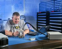 NASA Glenn engineer Norman Prokop refines microscope that could study Martian soil. (NASA)
