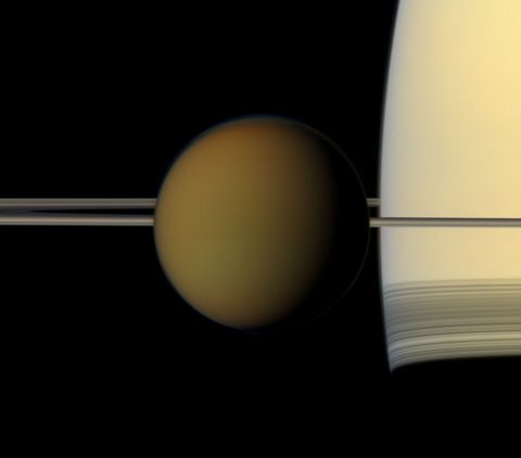 The hazy globe of Titan hangs in front of Saturn and its rings in this natural color view from NASA's Cassini spacecraft. (NASA/JPL-Caltech/Space Science Institute)