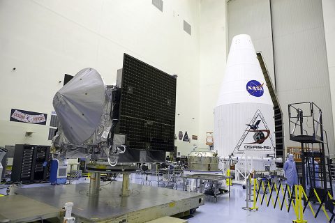 Inside the Payload Hazardous Servicing Facility at NASA's Kennedy Space Center in Florida, the agency’s OSIRIS-REx spacecraft is prepared for encapsulation Aug. 19 in its payload fairing. OSIRIS-Rex will be the first U.S. mission to sample an asteroid, retrieve at least two ounces of surface material and return it to Earth for study. (NASA/Glenn Benson)