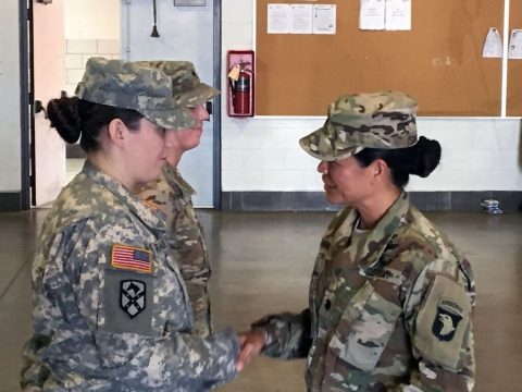 Lt. Col. Gina SanNicolas, commander of 129th Combat Sustainment Support Battalion, 101st Airborne Division (Air Assault) Sustainment Brigade, 101st Abn. Div., presents a coin of excellence to a Soldier of 2123rd Transportation Company from the Kentucky National Guard, Sept. 18, 2016, for going beyond the regular inactive duty training on Fort Knox, KY. (129th Combat Sustainment Support Battalion) 