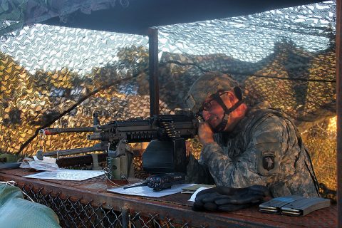 Spc. Judson Edel, a utility equipment repairer with 584th Support Maintenance Company, 129th Combat Sustainment Support Battalion, 101st Airborne Division (Air Assault) Sustainment Brigade, 101st Abn. Div., checks his range of fire and view on his M240B machine gun, Sept. 27, 2016, while taking over tower guard duty on Fort Campbell, Ky. (Pfc. Tyler Owen /129th Combat Sustainment Support Battalion UPAR) 