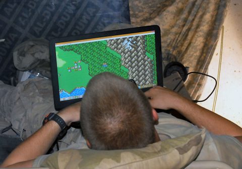 Pfc. Anthony Coward, a Soldier with Battery C, 1st Battalion, 320th Field Artillery Regiment, Task Force Strike, enjoys a game on his laptop Aug. 7, 2016, at Kara Soar Base, Iraq. With the installation of power generators during the deployment, Soldiers use technology to relax while in their sleeping areas during free time. (1st Lt. Daniel Johnson) 