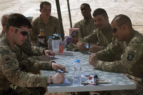 Soldiers with Battery C, 1st Battalion, 320th Field Artillery Regiment, Task Force Strike, enjoy a game of dominoes during down time Sept. 28, 2016, at Kara Soar Base, Iraq. As the deployment has gone on, Soldiers are staying resilient through a variety of different techniques – from games to physical fitness events. (1st Lt. Daniel Johnson)