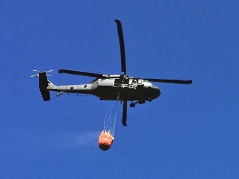 A Tennessee Army Guard Blackhawk Helicopter equipped with a Bambi Bucket conducts aerial firefighting on Signal Mountain, near Chattanooga on October 11, 2016. (Tennessee Forestry Division)