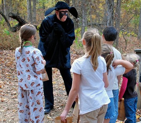 Otis the Bat talks with children along the trail and explains his role in the forest during the Howl-O-Ween program at Land Between the Lakes. (Nature Station staff) Otis the Bat talks with children along the trail and explains his role in the forest during the Howl-O-Ween program at Land Between the Lakes. (Nature Station staff)
