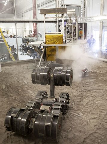 The MARCO POLO/Mars Pathfinder spacecraft undergoes an integrated test of an in-situ resource utilization, or ISRU, system. On the surface of Mars, mining robots like RASSOR will dig down into the regolith and take the material to a processing plant where usable elements such as hydrogen, oxygen and water can be extracted for life support systems. (NASA/Dimitri Gerondidakis)