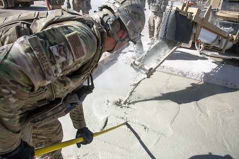 U.S Air Force Staff. Sgt. Tyler Charles, assigned to the 1st Expeditionary Civil Engineering Group, levels poured concrete into a trench at Qayyarah West airfield, Iraq, Oct. 8, 2017. A Coalition of regional and international nations have joined together to enable Iraqi forces to counter ISIL, reestablish Iraq’s borders and re-take lost terrain thereby restoring regional stability and security. (Spc. Christopher Brecht) 