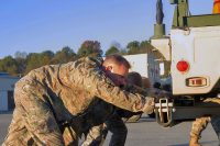 Col. Stanley Sliwinski, commander of the 101st Airborne Division (Air Assault) Sustainment Brigade, 101st Abn. Div., pushes a High Mobility Multipurpose Wheeled Vehicle with his team, Nov. 9, 2016, during the Command Team Physical Training Challenge at the 74th Composite Transportation Company motor pool on Fort Campbell, Ky. (Sgt. Neysa Canfield/101st Airborne Division Sustainment Brigade Public Affairs) 