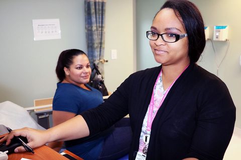 Candace Martin, a licensed practical nurse at Blanchfield Army Community Hospital, prepares to perform a fetal non-stress test on Monique Rich, a 32-week expectant mother who receives care within the Women's Health Clinic at BACH, November 3rd. 