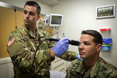 In a demonstration of the virtual health process, Lt. Col. Kevin A. Horde, a provider at Fort Gordon's Eisenhower Medical Center, offers remote consultation to mock patient Master Sgt. Jason H. Alexander with the nursing assistance of Lt. Maxx P. Mamula at Fort Campbell's Blanchfield Army Community Hospital. (David E. Gillespie)