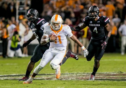 Tennessee Volunteers quarterback Joshua Dobbs (11) scrambles past South Carolina Gamecocks defensive lineman Marquavius Lewis (8) and South Carolina Gamecocks linebacker Bryson Allen-Williams (4) in the first quarter at Williams-Brice Stadium. (Jeff Blake-USA TODAY Sports)