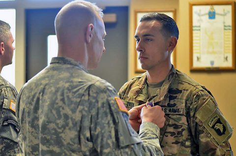 Sgt. Addison Owen, right, 1st Battalion, 26th Infantry Regiment, Task Force Strike, 2nd Brigade Combat Team, receives the purple heart medal from Col. Brett G. Sylvia, left, commander, 2nd Brigade Combat Team, 101st Airborne Division (Air Assault) during a ceremony at Fort Campbell, Kentucky, Dec. 18, 2015. Owen was wounded while assigned to the 1st Cavalry Division in Iraq during a 2010-2011 rotation. (Staff Sgt. Sierra Melendez) 