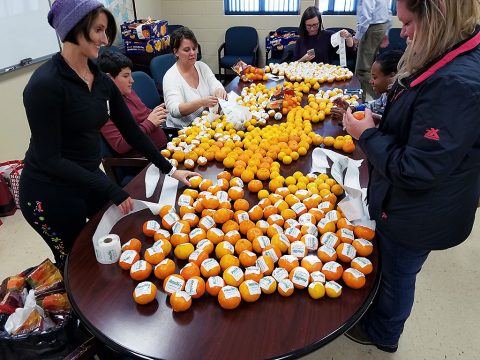 Members of the Mayor’s Fitness Council worked Friday to place HealthyClarksville.com stickers on 3,000 oranges that were distributed from the City of Clarksville’s float during the Clarksville Christmas Parade. Healthy Clarksville is an arm of the Fitness Council which helped Clarksville earn designation as a “Healthier TN Community.” 