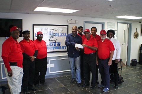 Richard Garrett receiving a check for $1000 from Double Bogey Charitable Golf Club’s President Henry Parham