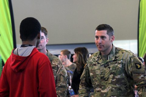 Chief Warrant Officer 1 Jason Emig, the network management technician for 101st Airborne Division (Air Assault) Sustainment Brigade, 101st Abn. Div., listens to a student asking questions about the communications career field of the military, Nov. 16, 2016, during the Eighth-Grade Career Exploration Day. (Sgt. Neysa Canfield/101st Airborne Division Sustainment Brigade Public Affairs)