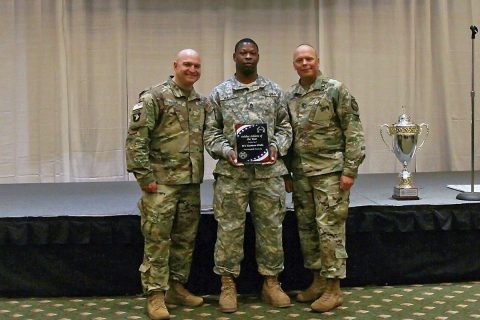 Sgt. 1st Class Keatron Walls (center), a mechanic with 227th Quartermaster Company, 129th Combat Sustainment Support Battalion, 101st Airborne Division (Air Assault) Sustainment Brigade, 101st Abn. Div., receives the Soldier Athlete of the Year Award, Nov. 17, 2016, during a ceremony at Cole Park Commons Conference Center on Fort Campbell, Ky. (Sgt. Neysa Canfield/101st Airborne Division Sustainment Brigade Public Affairs) 