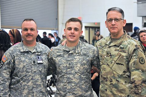 Sgt. Maj. Chris Davenport and Staff Sgt. William Jones say farewell to Pfc. Aaron Jones at a good-bye ceremony for the 230th Signal Company at Houston Barracks on December 4. For Aaron Jones, the oldest son of William Jones, this will be his first deployment. All three Soldiers are from Ashland City. (Sgt. 1st Class Edgar Castro)