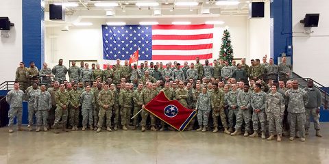 Guardsmen from Nashville's 230th Signal Company pose for company photograph prior to boarding a bus to begin their journey to Fort Hood, Texas, for roughly one month of pre-deployment training. Following their training, the Soldiers will deploy to Kuwait for one year in support of Operation Spartan Shield. (Sgt. 1st Class Edgar Castro)