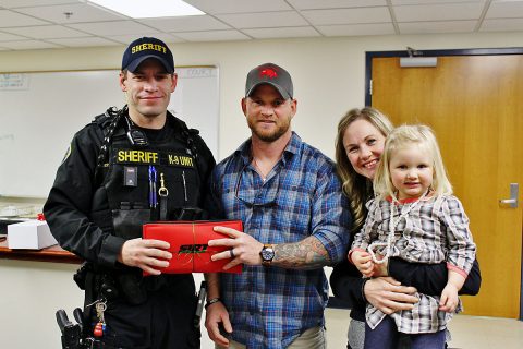 Drew Estell donates a Shot Indicating Resetting Trigger (SIRT) Training Pistol to the Montgomery County Sheriff's Office.